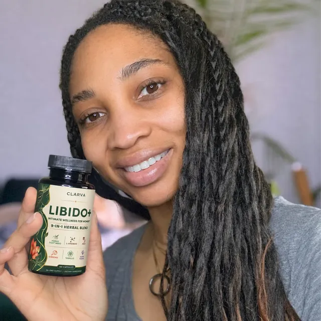 A person holding a CLARVA LIBIDO+ bottle