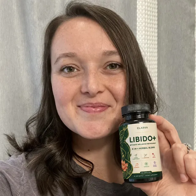 A person holding a CLARVA LIBIDO+ bottle