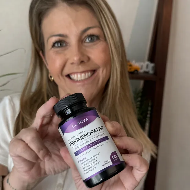 A person holding a CLARVA PERIMENOPAUSE bottle