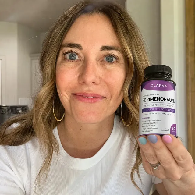 A person holding a CLARVA PERIMENOPAUSE bottle