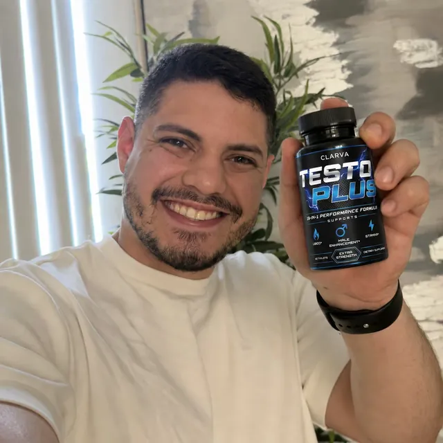 A person holding a CLARVA TESTO PLUS bottle
